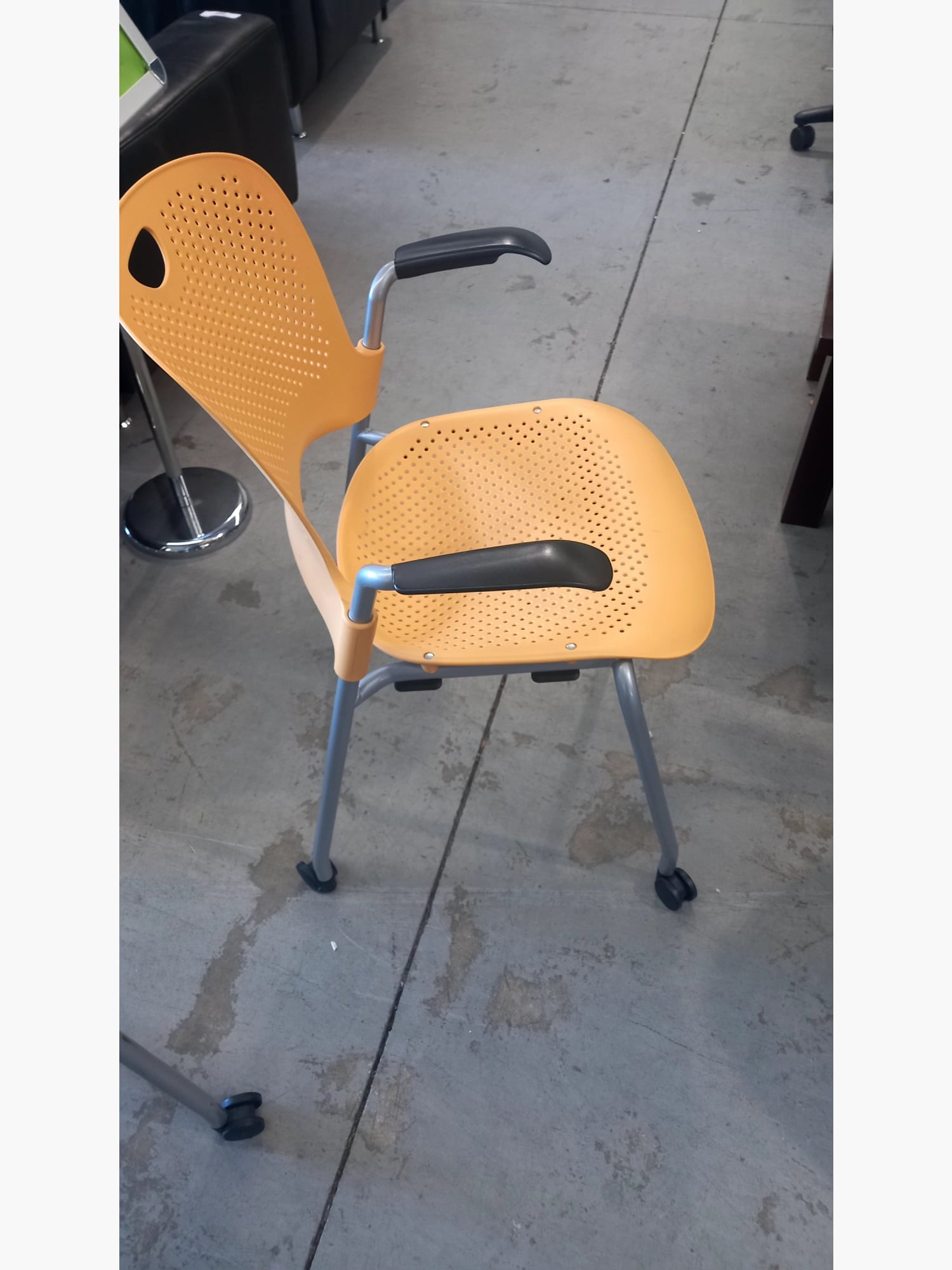 Herman Miller - Stack Chair With Arms On Wheels Yellow stacking chairs